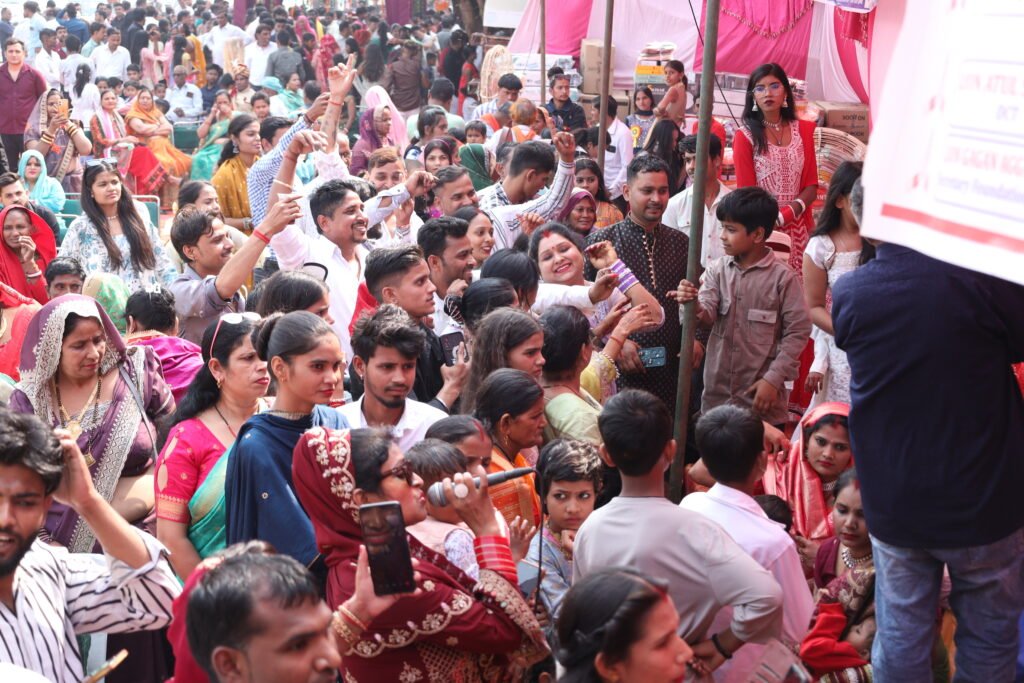 Mass marriage ceremony in India with large crowd supporting underprivileged couples